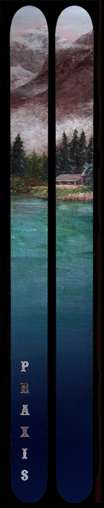 A pair of skis that show a mountain-side cabin sitting near a lake